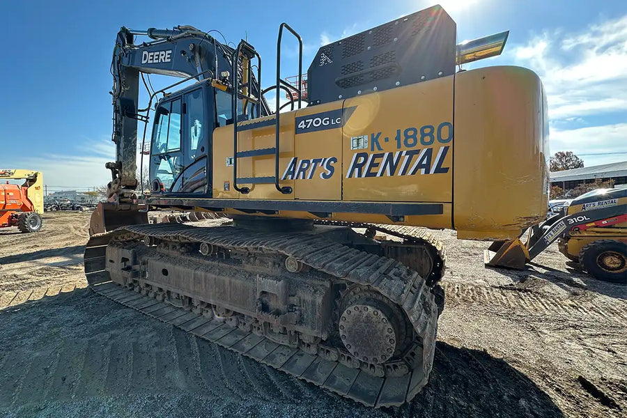 Yellow excavator with 'Art's Rental' branding on a construction site.