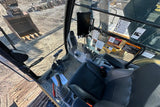 Operator's seat and controls inside a construction vehicle on a job site