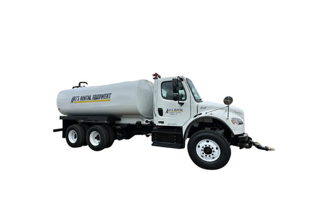 White truck with a large cylindrical tank for water
