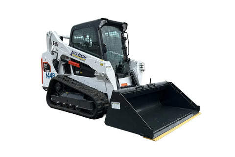 Bobcat skid steer loader with smooth bucket attachment and enclosed cab.